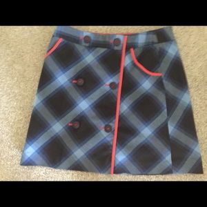 Navy and blue plaid skort with red accents.